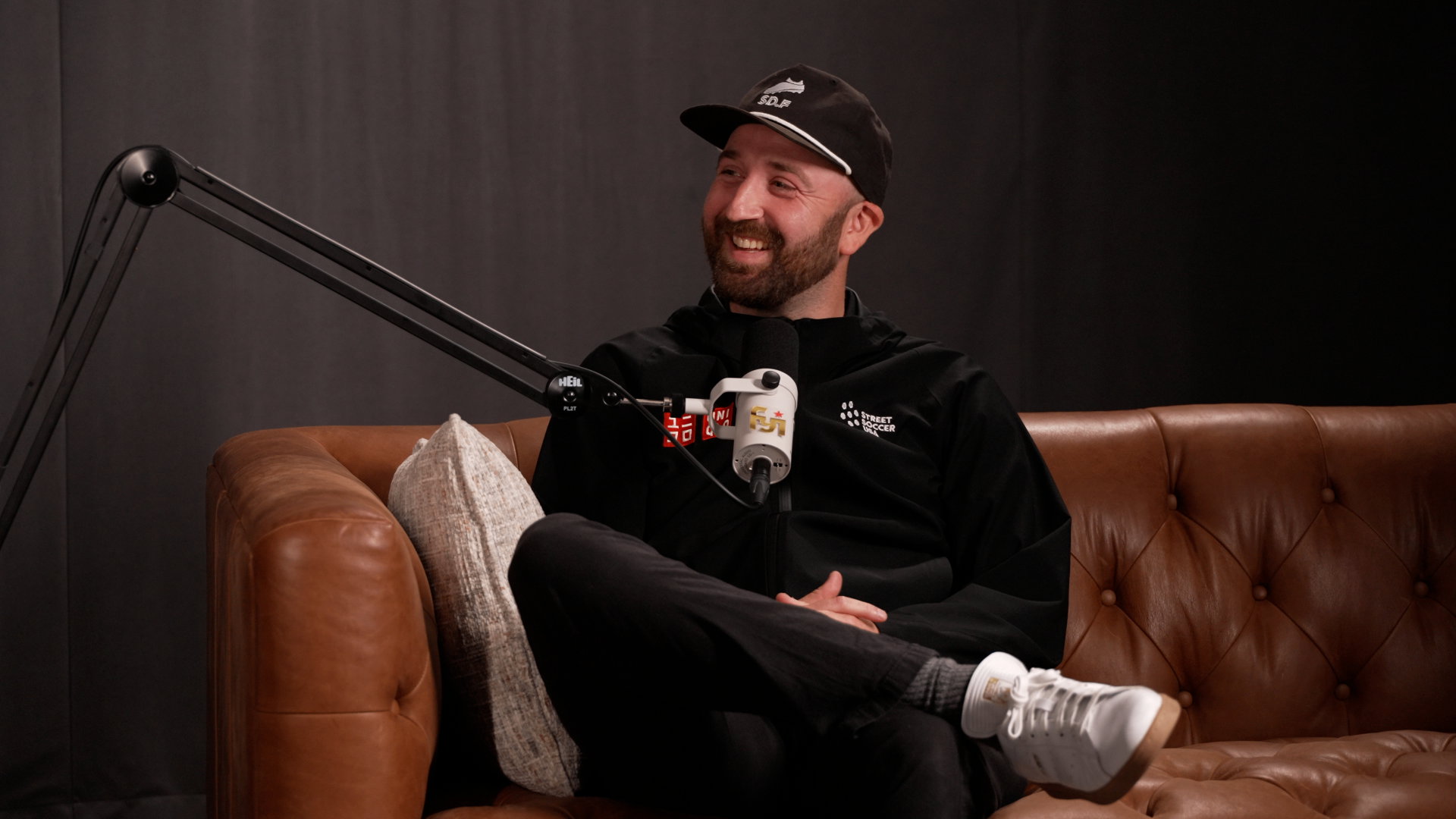 Two podcast hosts in an authentic conversation in a studio
